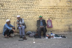 Three old men sitting outside